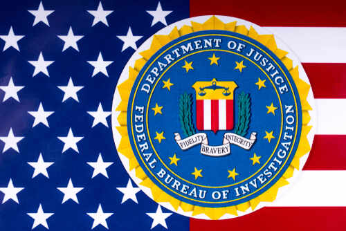 London,,Uk,-,March,26th,2018:,The,Seal,Of,The FBI seal overlaid on an American flag background