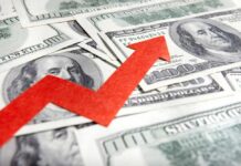 Confidence Craters As Prices Spike A red arrow indicating growth over scattered hundred dollar bills