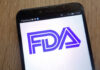 FDA Missed Seven Years — Outbreak Explodes Close-up of a smartphone displaying the FDA logo