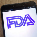 FDA Missed Seven Years — Outbreak Explodes Close-up of a smartphone displaying the FDA logo