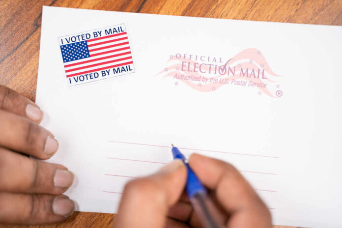 Maski,,India,-,23,,June,2020,:,Hands,Filling,Out Hands addressing an official election mail envelope