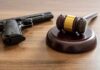 Texas Judge Shreds 90-Year Gun Rule Judge's gavel and handgun on wooden table