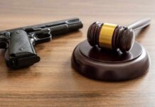 Texas Judge Shreds 90-Year Gun Rule Judge's gavel and handgun on wooden table
