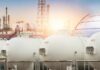 Gas storage tanks in an industrial facility during sunrise
