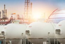 NEWS ALERT: America’s Safety Net VANISHES Gas storage tanks in an industrial facility during sunrise