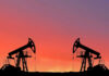 Energy Earthquake: 65B Barrels, Zero Tax Bill Oil pumps silhouetted against colorful sky background