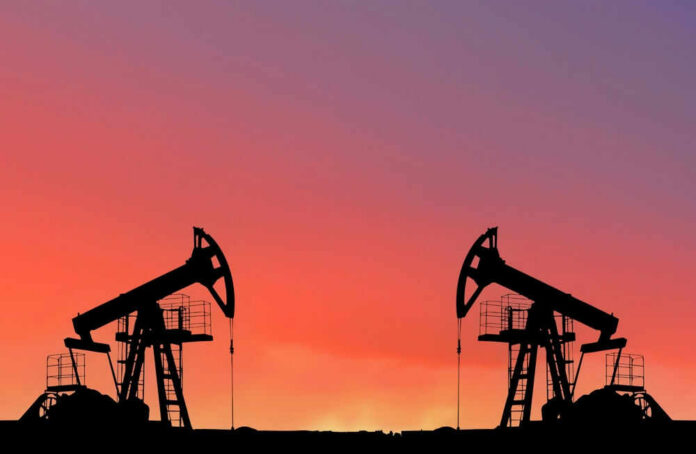 shutterstock_2207212903 Oil pumps silhouetted against colorful sky background