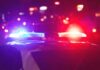 Deadly Classroom Carnage: Police Move Fast Police car with flashing red and blue lights at night