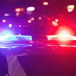 Deadly Classroom Carnage: Police Move Fast Police car with flashing red and blue lights at night