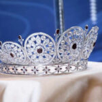 Shock Return, But No Royal Comeback Silver and gemstone crown on display.