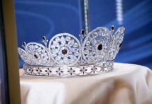 Silver and gemstone crown on display.