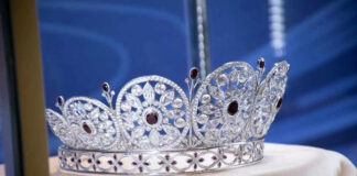 Silver and gemstone crown on display.