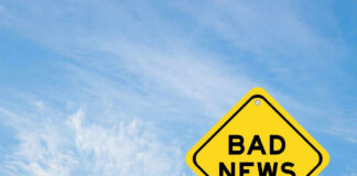 Yellow sign reads bad news in sky