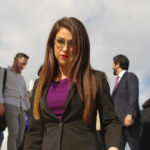 Instagram Video Sparks Explosive Boebert Case Lauren Boebert with glasses walking, people in the background.