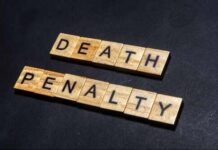 Court Drops The Hammer – DEATH! Wooden letter tiles spelling DEATH PENALTY on a dark background
