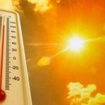 Heatwave Grounds Planes — Physics Wins Thermometer displaying high temperature against a bright sun