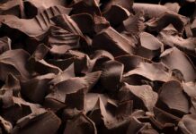 Cocoa Chaos Ends: Kirkland Chips Reappear Close-up of dark chocolate shavings scattered on a surface