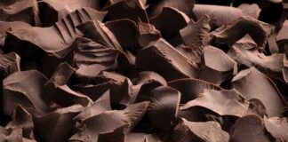 Close-up of dark chocolate shavings scattered on a surface