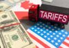 U.S.–Canada Trade Brawl Turns Brutal Toy truck labeled tariffs between US and Canada flags with cash