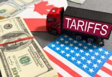 U.S.–Canada Trade Brawl Turns Brutal Toy truck labeled tariffs between US and Canada flags with cash