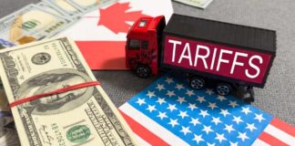 Toy truck labeled tariffs between US and Canada flags with cash