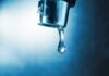 Water Emergency Slams San Juan Hand filling pitcher with water from faucet.
