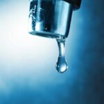 Water Emergency Slams San Juan Hand filling pitcher with water from faucet.