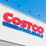 Costco Wholesale store sign against a blue sky