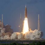 Musk’s $100B Spaceport Shocks Louisiana Rocket launching from a coastal pad at dawn with bright exhaust plume