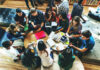 Group of young adults studying in a library.