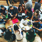 Group of young adults studying in a library.