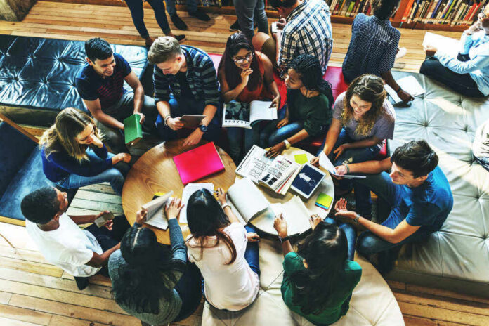 shutterstock_427333528 Group of young adults studying in a library.