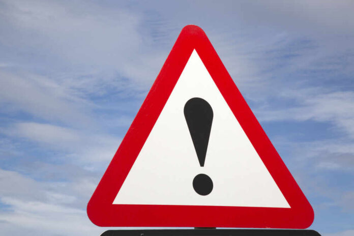 Exclamation,Mark,Traffic,Warning,Sign Warning road sign with exclamation mark against a cloudy sky