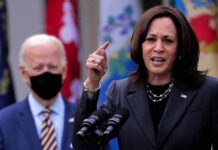 Kamala Caught Faking It?! Kamala Harris speaking at podium with Joe Biden in background
