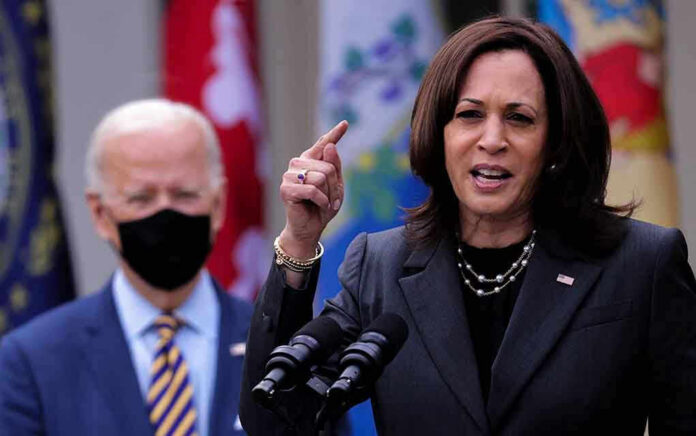 1958383042 Kamala Harris speaking at podium with Joe Biden in background