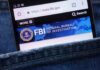 BOMBSHELL: FBI Agents’ Medical Files Exposed Mobile phone displaying the FBI website in a denim pocket