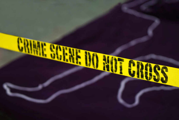 Yellow crime scene tape marking off an area with a chalk outline