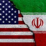 VIDEO: U.S. Strikes — Iran Stunned A cracked surface displaying the flags of the USA and Iran