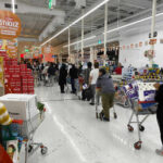 Checkout Shock: Walmart Goes Tap Shoppers queue with carts in a supermarket checkout area