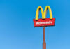 McDonald's restaurant sign against a clear blue sky