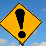 Yellow caution sign with exclamation mark symbol.
