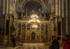 Buried Garden Shocks Holy Sepulchre Archaeologist brushes fossils in a sand tray under a magnifying lamp