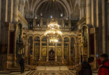 Buried Garden Shocks Holy Sepulchre Archaeologist brushes fossils in a sand tray under a magnifying lamp