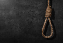 Hanging Death Shocker Triggers Arrest A noose made of rope hanging against a dark textured background