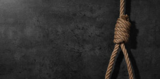 A noose made of rope hanging against a dark textured background