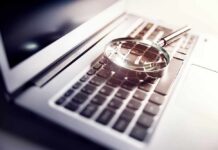 Tylenol Murders Resurface – Suspect Identified A magnifying glass resting on a laptop keyboard