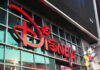 Disney sign on building with Mickey Mouse figure
