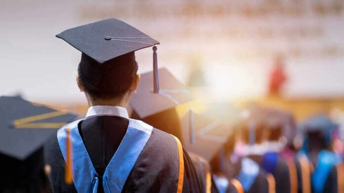 Graduates wearing caps and gowns in a ceremony.