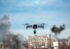 Drug Cartel Drone Gambit Exposed Drone flying over urban area with smoke plumes.