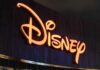 Illuminated Disney logo against a dark background